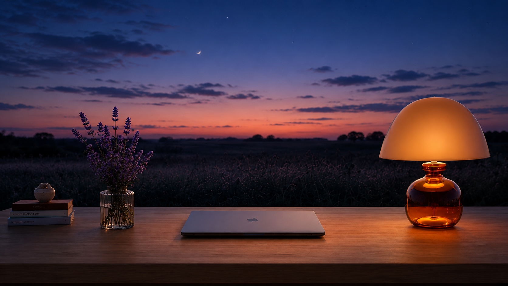 Atelier at dusk — warm lamp glow under a violet sky and crescent moon.